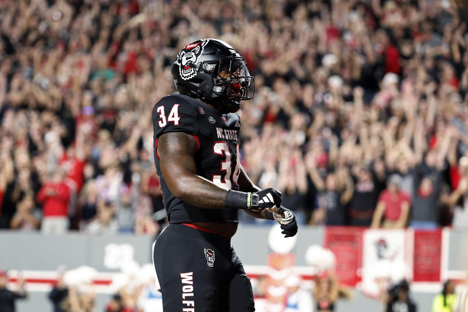 North Carolina State's Delbert Mimms III celebrates his touchdown against Louisville during the first half of an NCAA college football game in Raleigh, N.C., Friday, Sept. 29, 2023. (AP Photo/Karl B DeBlaker)