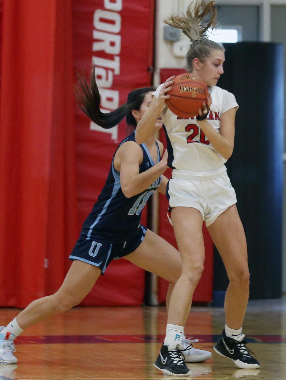 Ketcham's Caitlin Robertson, with her back to the basket, looks to make a move against an Ursuline defender during a Dec. 28, 2022 girls basketball game.