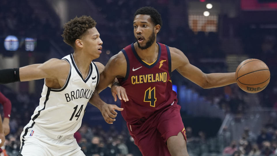 Cleveland Cavaliers' Evan Mobley (4) drives against Brooklyn Nets' Kessler Edwards (14) in the first half of an NBA basketball game, Monday, Jan. 17, 2022, in Cleveland. (AP Photo/Tony Dejak)