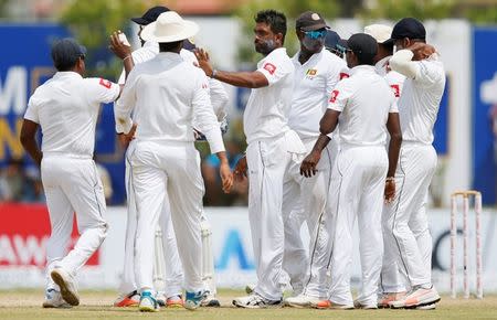 Cricket - Sri Lanka v South Africa - First Test Match - Galle, Sri Lanka - July 14, 2018 - Sri Lanka's Dilruwan Perera (C) celebrates with team mates after taking the wicket of South Africa's Quinton de Kock (not pictured). REUTERS/Dinuka Liyanawatte
