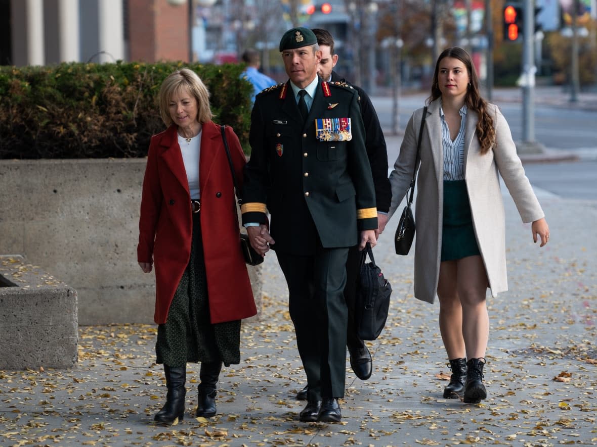 Maj.-Gen. Dany Fortin, right, arrives in uniform with his wife Madeleine Collin and daughter at a Gatineau, Que. courthouse on Monday. (Spencer Colby/The Canadian Press - image credit)