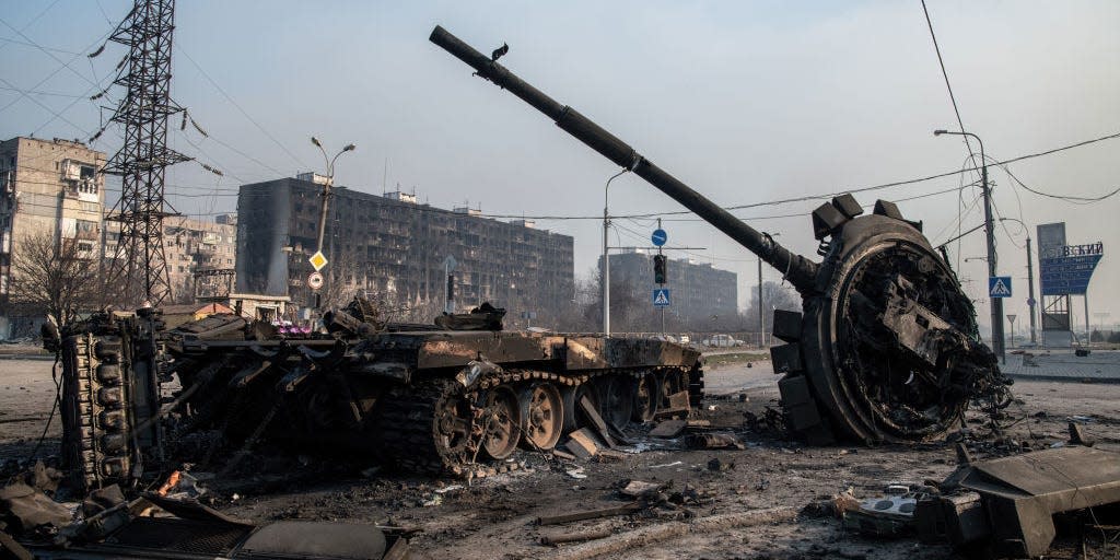 A destroyed tank likely belonging to Russia / pro-Russian forces lies amidst rubble in the north of the ruined city of Mariupol on March 23, 2022.