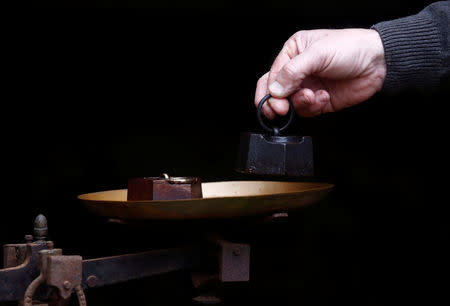 Two one kilogram weights are seen on a vintage scale in Saussay-la-Campagne, western France, November 15, 2018. REUTERS/Christian Hartmann