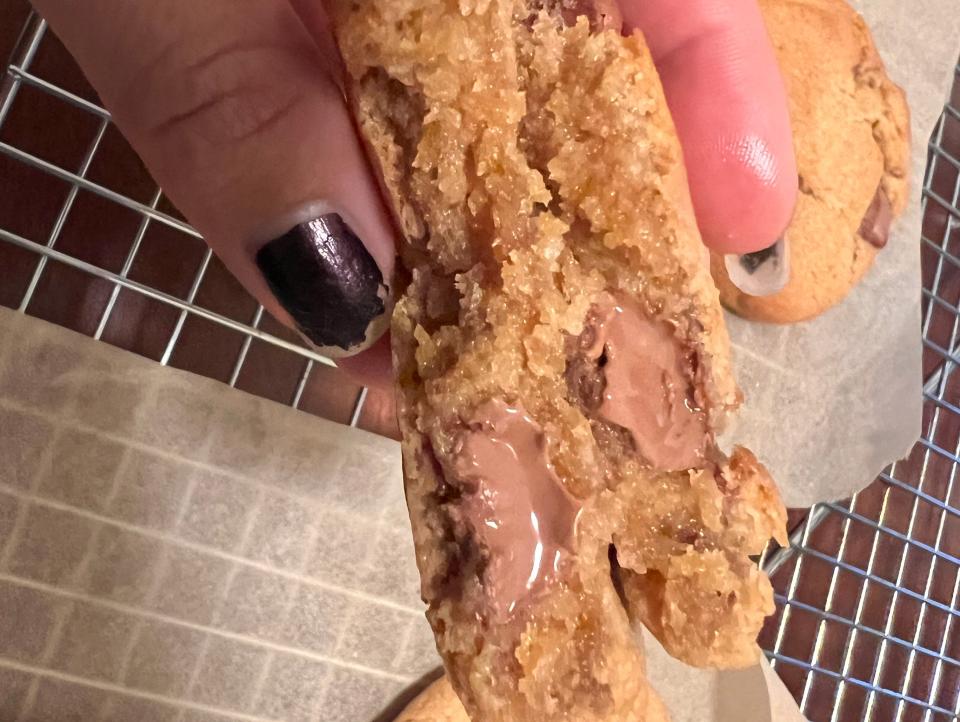 hand holding cross section of air fried chocolate chip cookie