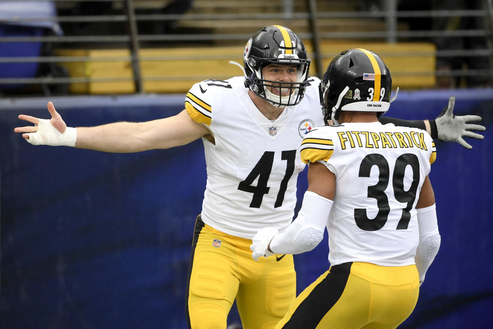 Pittsburgh Steelers linebacker Robert Spillane, left, celebrates with free safety Minkah Fitzpatrick after after scoring on an interception of a pass from Baltimore Ravens quarterback Lamar Jackson, not visible, during the first half of an NFL football game, Sunday, Nov. 1, 2020, in Baltimore. (AP Photo/Nick Wass)