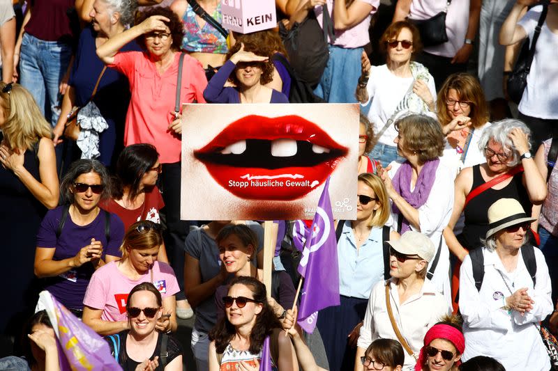 A protester carries a placard reading "Stop domestic abuse" at a demonstration during a women's strike (Frauenstreik) in Zurich