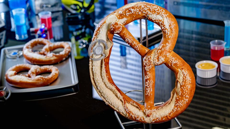 Pym Test Kitchen in Avengers Campus features Experiment No. IP42: Quantum Pretzel. It's been supersized (360 gras) and comes with mustard and beer cheese dipping sauce. You might grab Thor for help eating.
