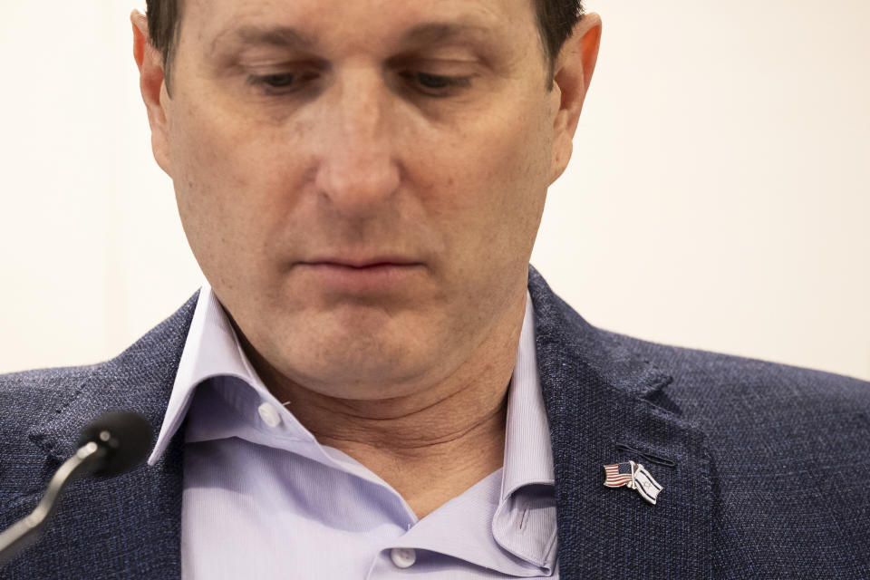Congressman Dan Goldman is seen wearing a pin of American and Israeli flag during a press conference by families of American hostages in Gaza and elected officials, Friday, April. 5, 2024, in New York. (AP Photo/Yuki Iwamura)