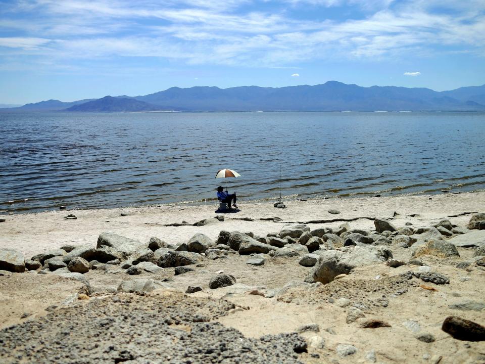 A man fishes along the receding banks of the Salton Sea near Bombay Beach in 2015.