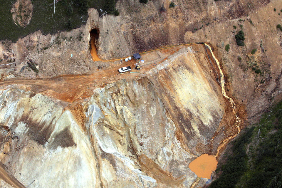 FILE - Wastewater continues to stream out of the Gold King Mine near Silverton, Colo., on Aug.11, 2015. Colorado, the U.S. government and a gold mining company have agreed to resolve a longstanding dispute over who’s responsible for cleanup at a Superfund site that was established after a massive 2015 spill of hazardous mine waste. The proposed settlement announced Friday, Jan. 21, 2022, would direct $90 million to cleanup at the Bonita Peak Mining District Superfund site, according to the U.S. Environmental Protection Agency and Denver-based Sunnyside Gold Corp(Geoff Liesik/The Deseret News via AP, File)