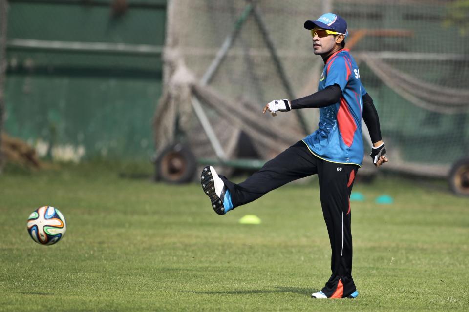 Bangladesh cricket team captain Mushfiqur Rahim plays with a soccer ball during a practice session ahead of the Asia Cup tournament in Dhaka, Bangladesh, Monday, Feb. 24, 2014. Pakistan plays Sri Lanka in the opening match of the five nation one day cricket event that begins Tuesday. (AP Photo/A.M. Ahad)