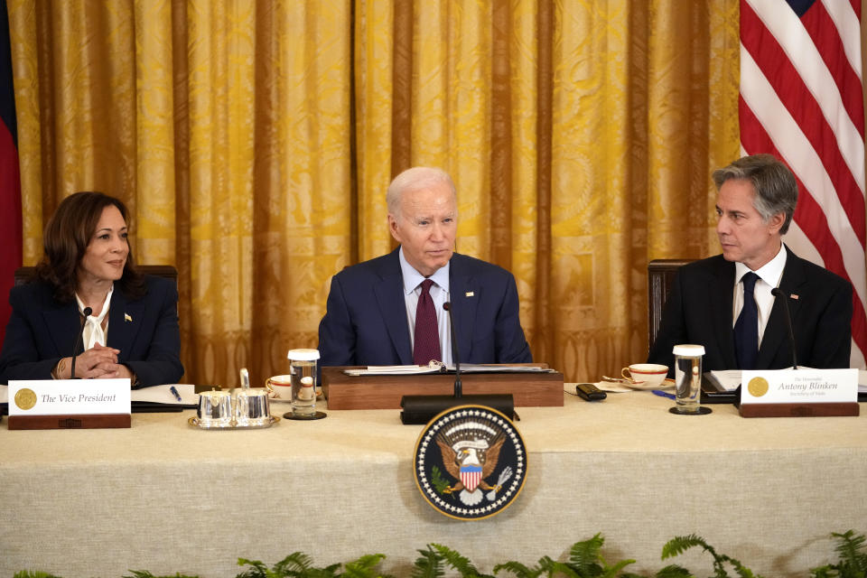 President Joe Biden, center, speaks as Vice President Kamala Harris, left, and Secretary of State Antony Blinken, listen during a trilateral meeting with Philippine President Ferdinand Marcos Jr. and Japanese Prime Minister Fumio Kishida in the East Room of the White House in Washington, Thursday, April 11, 2024. (AP Photo/Mark Schiefelbein)