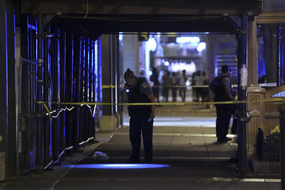 Chicago police look for evidence on South State Street in downtown Chicago after a shooting on Saturday, May 14, 2022, (Terrence Antonio James/Chicago Tribune via AP)