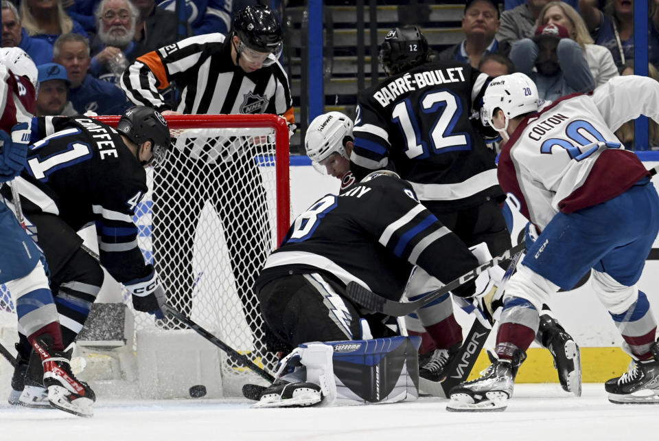Colorado Avalanche center Ross Colton (20) scores against the Tampa Bay Lightning during the second period of an NHL hockey game Thursday, Feb. 15, 2024, in Tampa, Fla. (AP Photo/Jason Behnken)