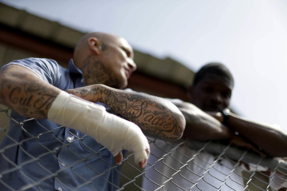 Inmates watch as visitors arrive at the Angola Prison Rodeo in Angola, La., Saturday, April 26, 2014. Louisiana’s most violent criminals, many serving life sentences for murder, are the stars of the Angola Prison Rodeo, the nation’s longest-running prison rodeo that this year celebrates 50 years. The event has grown from a small “fun” event for prisoners into big business, with proceeds going into the Louisiana State Penitentiary Inmate Welfare Fund for inmate education and recreational supplies. (AP Photo/Gerald Herbert)