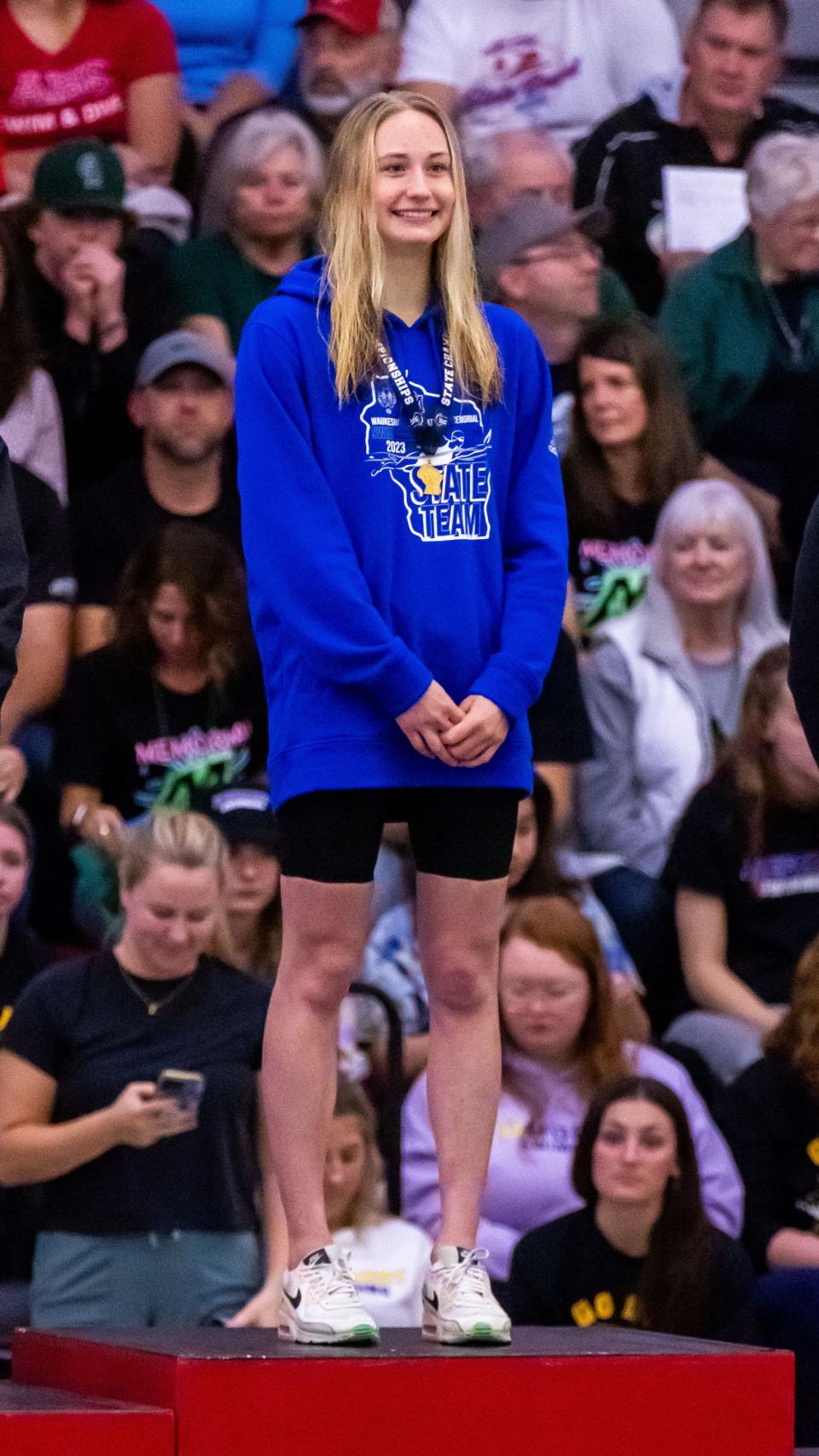 Waukesha West/Catholic Memorial co-op's Olivia Wanner stands on the podium after winning the 50-yard freestyle in the WIAA Division 1 girls state swimming and diving championships at Waukesha South on Saturday, November 11, 2023.