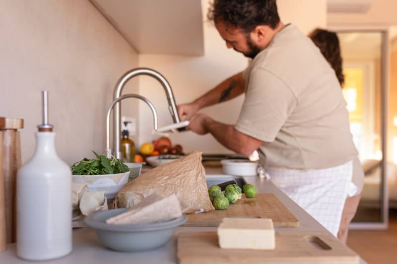 Dweller making food in kitchen.