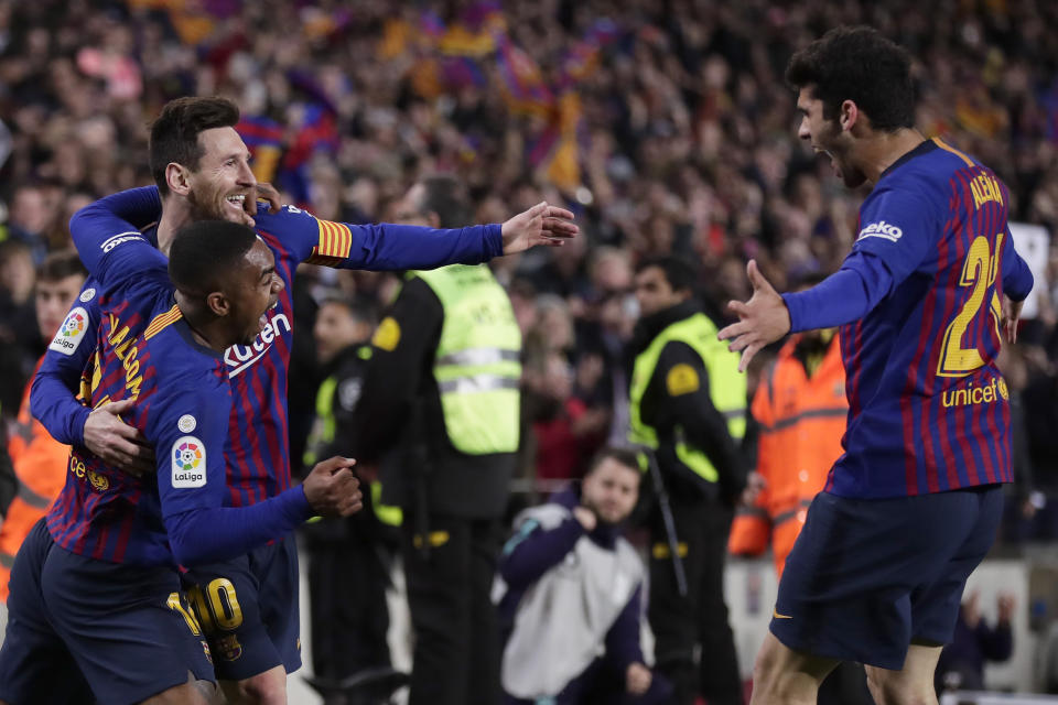Barcelona forward Lionel Messi, rear left, celebrates with teammates Malcom, left, and Carles Alena, right, after he scored his side's second goal during a Spanish La Liga soccer match between FC Barcelona and Atletico Madrid at the Camp Nou stadium in Barcelona, Spain, Saturday April 6, 2019. (AP Photo/Manu Fernandez)