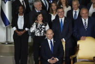 Israeli Prime Minister Naftali Bennett, seated, smiles as he waits to pose for a group photo with the ministers of the new government at the President's residence in Jerusalem, Monday, June 14, 2021. (AP Photo/Maya Alleruzzo)