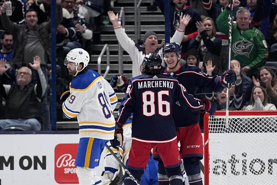 Columbus Blue Jackets left wing Dmitri Voronkov (10) celebrates his goal with Kirill Marchenko (86) as Buffalo Sabres right wing Alex Tuch (89) skates past the first period of an NHL hockey game Friday, Feb. 23, 2024, in Columbus, Ohio. (AP Photo/Sue Ogrocki)