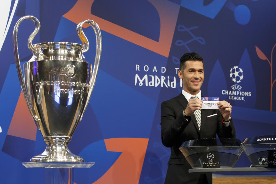 Former Spain's soccer player Luis Garcia, ambassador for the UEFA Champions League, shows a ticket of Spain's club Real Madrid CF, during the drawing of the matches for the Champions League 2018/19 Round of 16, at the UEFA headquarters in Nyon, Switzerland, Monday, Dec. 17, 2018. (Salvatore Di Nolfi/Keystone via AP)