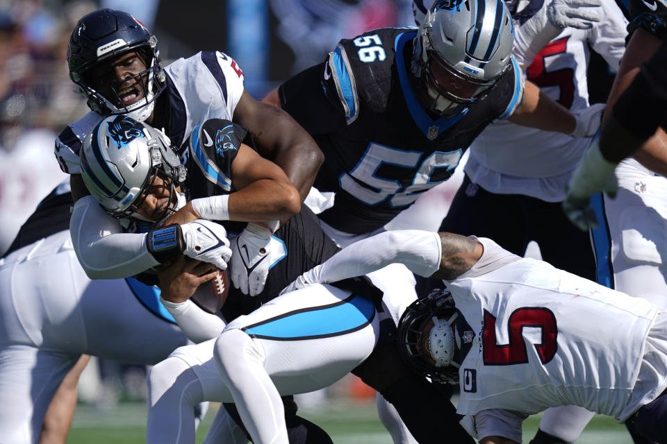 Houston Texans defensive end Will Anderson Jr. (51) sacks Carolina Panthers quarterback Bryce Young (9) with the help of safety Jalen Pitre (5) during the first half of an NFL football game, Sunday, Oct. 29, 2023, in Charlotte, N.C. (AP Photo/Erik Verduzco)