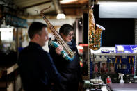 A worker holds a tenor saxophone at the Henri Selmer wind instruments factory in Mantes-la-Ville near Paris, France, January 17, 2018. REUTERS/Benoit Tessier