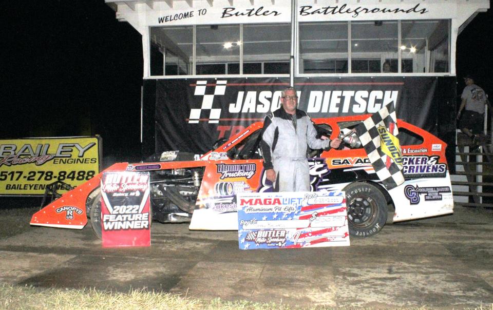 Corey Bevard poses in Victory Lane after taking the top spot in the MAGA Lift UMP Modified Division on Saturday