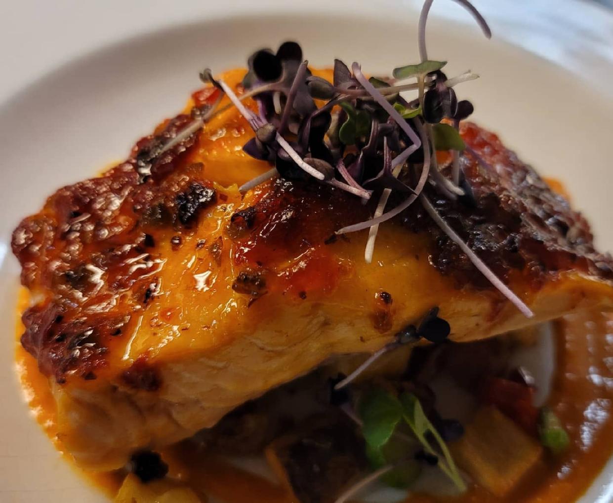 The menu at Citron Bistro in Hobe Sound features a hot pepper-bacon jam-crusted salmon with potato hash, asparagus and red pepper sauce.