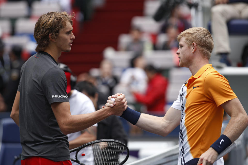 Alexander Zverev of Germany, left, shakes hands with Kyle Edmund of Britain after winning the men's singles quarterfinals match in the Shanghai Masters tennis tournament at Qizhong Forest Sports City Tennis Center in Shanghai, China, Friday, Oct. 12, 2018. (AP Photo/Andy Wong)