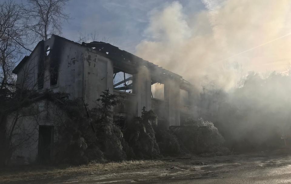 An abandoned building in Craigsville continued to smolder Friday morning, Jan. 5, 2024, after catching fire hours earlier.