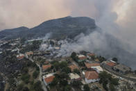 An aerial view of the burning Sirtkoy village, near Manavgat, Antalya, Turkey, Sunday, Aug. 1, 2021. More than 100 wildfires have been brought under control in Turkey, according to officials. The forestry minister tweeted that five fires are continuing in the tourist destinations of Antalya and Mugla. (AP Photo)