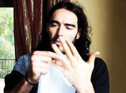 Russell Brand takes off his wedding ring in a video promoting a college tour. Credit: You Tube.