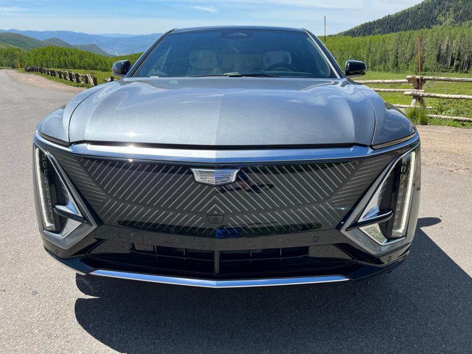 The 2023 Cadillac Lyriq electric SUV's distinctive slim vertical LED headlights, lighted grille panel and badge make the car immediately identifiable in daylight and at night.