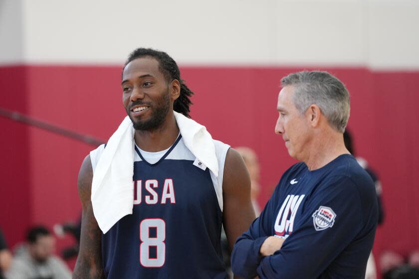 Clippers star Kawhi Leonard and Chip Engelland, of the USA Basketball men's select team, smile during training camp