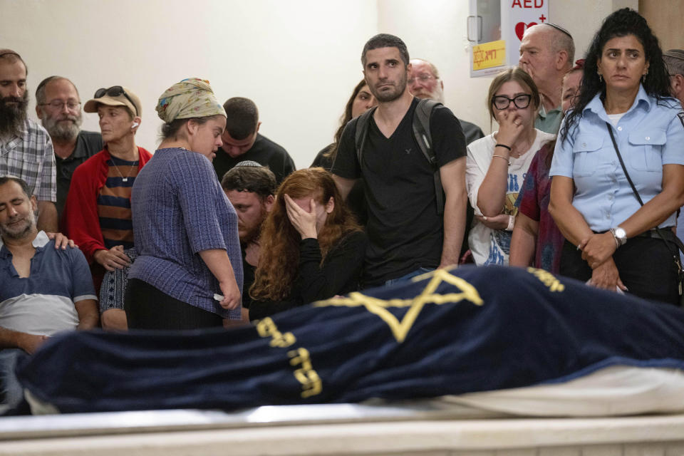 Mourners attend the funeral of Batsheva Nigri, at a cemetery in the West Bank Jewish settlement of Kfar Etzion, Monday, Aug. 21, 2023. Israeli authorities say that a suspected Palestinian attacker has killed an Israeli woman and seriously wounded a man in the incident. (AP Photo/Ohad Zwigenberg)