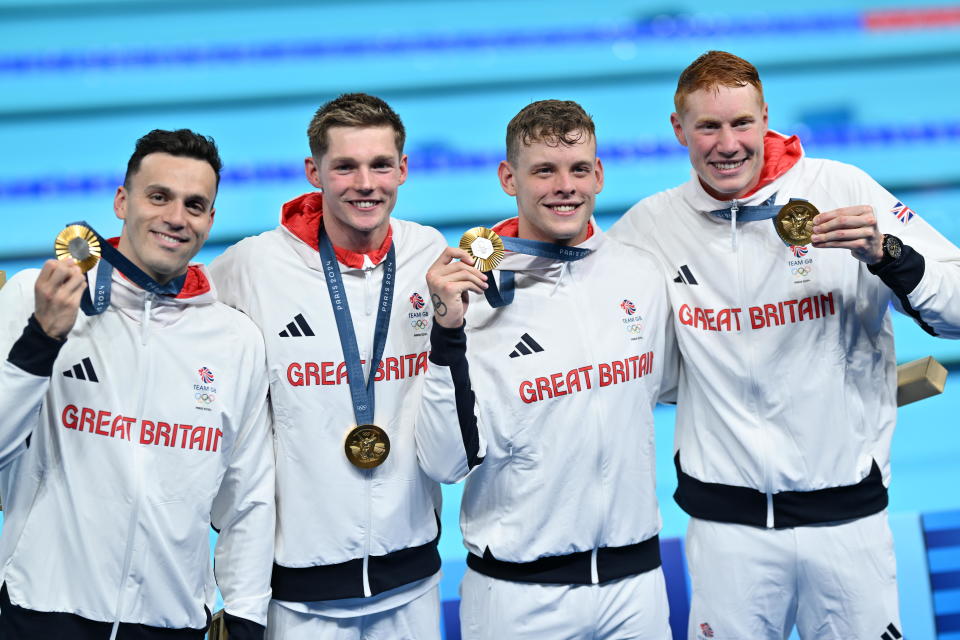 PARIS, FRANCE - JULY 30: Tom Dean (R), Duncan Scott (C-L), Matthew Richards (C-R) and James Guy (L) of Great Britain Team celebrate after winning gold in the Men's 4x200m Freestyle Relay Final at the Paris La Defense Arena in Nanterre, west of Paris, France on July 30, 2024. (Photo by Mustafa Yalcin/Anadolu via Getty Images)