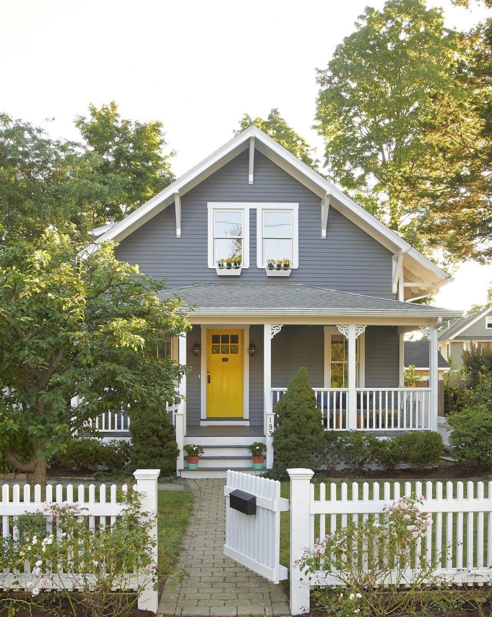 grey house with a yellow door