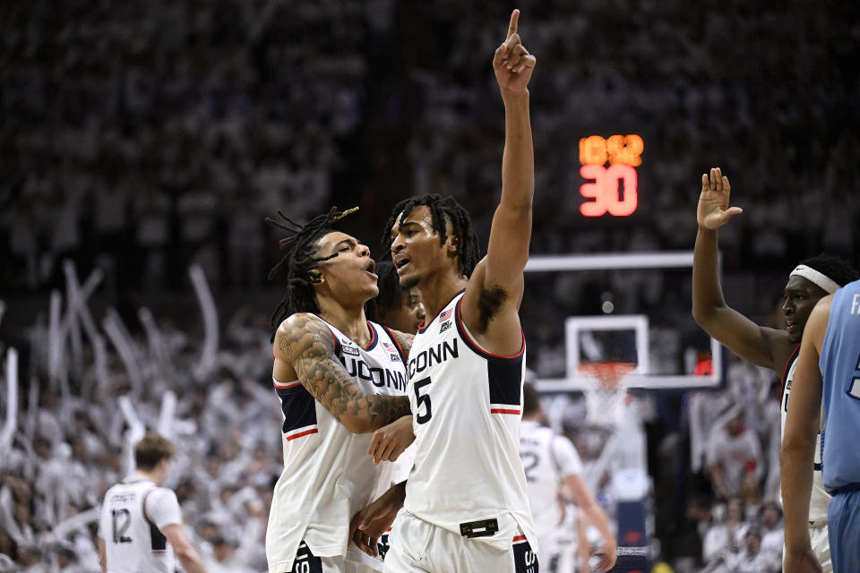 UConn guard Stephon Castle, right, celebrates with UConn guard Solomon Ball, left, in the second half of an NCAA college basketball game against Creighton, Wednesday, Jan. 17, 2024, in Stores, Conn. (AP Photo/Jessica Hill)