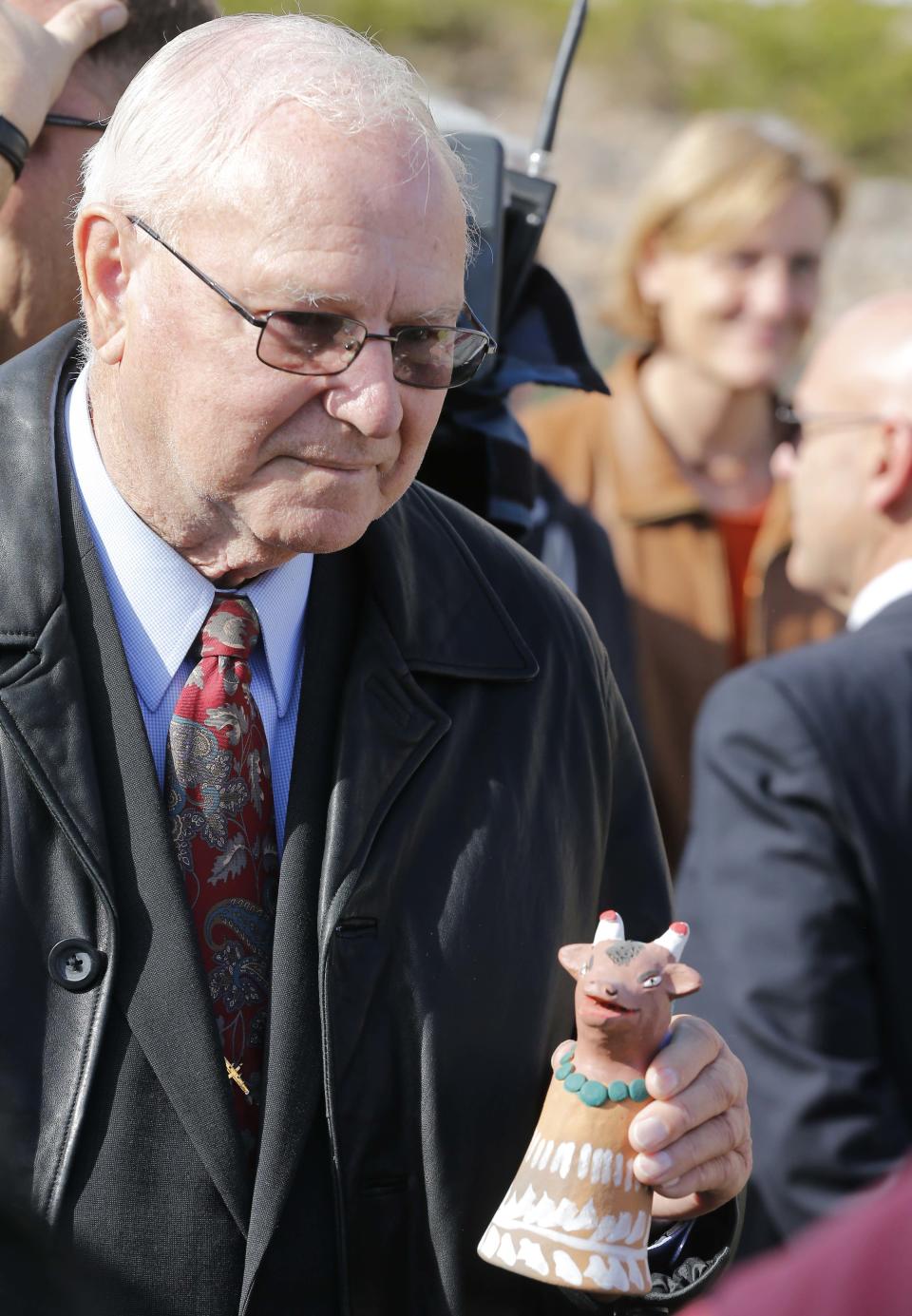 Tucson shooting survivor Bill Posey rings a bell during a remembrance ceremony on the third anniversary of the Tucson shootings, Wednesday, Jan. 8, 2014, in Tucson, Ariz. Six people were killed and 13 wounded, including U.S. Rep. Gabrielle Giffords, D-Ariz., in the shooting rampage at a community event hosted by Giffords in 2011. Jared Lee Loughner was sentenced in November 2012 to seven consecutive life sentences, plus 140 years, after he pleaded guilty to 19 federal charges in the shooting. (AP Photo/Matt York)