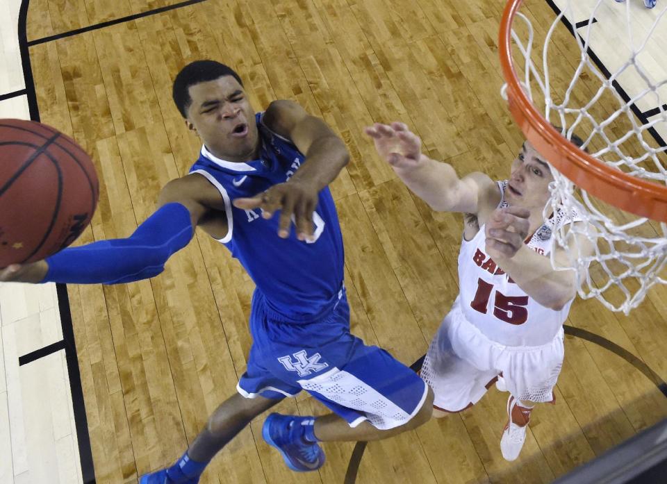 Kentucky guard Andrew Harrison (5) drives to the basket past Wisconsin forward Sam Dekker, right, during the first half of an NCAA Final Four tournament college basketball semifinal game Saturday, April 5, 2014, in Arlington, Texas. (AP Photo/Chris Steppig, pool)