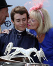 Jockey Mickael Barzalona (L) gets a kiss after winning The Derby horse race during the second day of the Epsom Derby Festival, in Surrey, southern England, on June 4, 2011. Pour Moi, ridden by Jockey Mickael Barzalona won the race, Treasure Beach came second and race favorite Carlton House came third place. The Queen's horse, Carlton House, ridden by Ryan Moore, was seeking to be the first Derby winner owned by a reigning monarch since Minoru won in 1909 for King Edward VII. AFP PHOTO / ADRIAN DENNIS (Photo credit should read ADRIAN DENNIS/AFP/Getty Images)