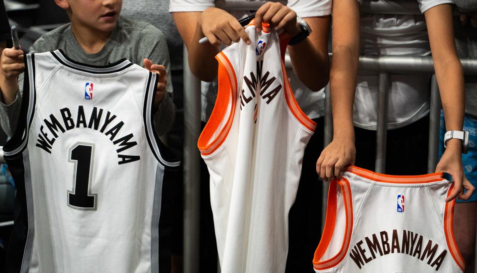 Young San Antonio Spurs fans hold jerseys, hoping for autographs, ahead of the Spur's I-35 series game at the Moody Center in Austin, Friday March 15, 2024. The Spurs lost to the Denver Nuggets 106-117.
