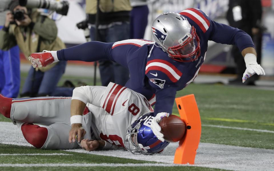 New England Patriots linebacker Kyle Van Noy dives over New York Giants quarterback Daniel Jones to score a touchdown after returning a fumble he recovered in the second half of an NFL football game, Thursday, Oct. 10, 2019, in Foxborough, Mass. (AP Photo/Elise Amendola)