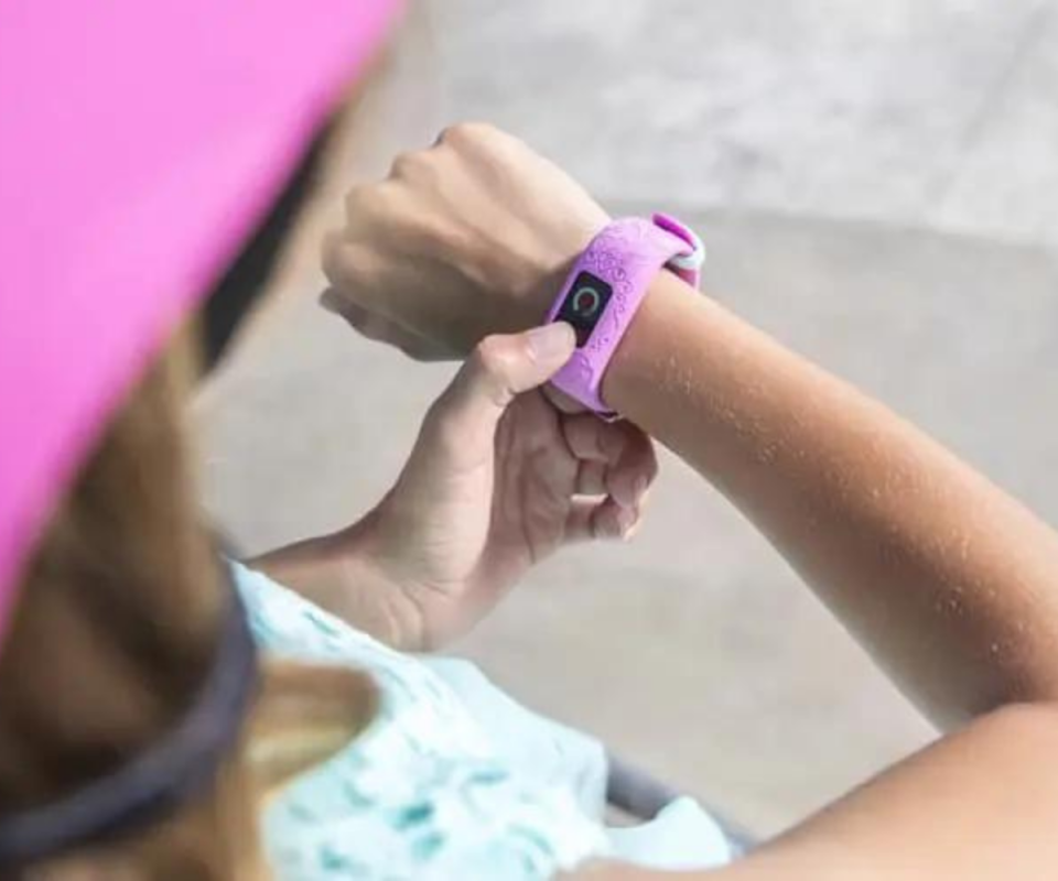 Close up of girl touching her Garmin VivoFit Jr. 