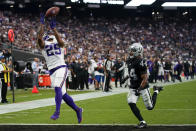 Minnesota Vikings wide receiver Albert Wilson catches a touchdown pass ahead of Las Vegas Raiders cornerback Bryce Cosby during the second half of an NFL preseason football game, Sunday, Aug. 14, 2022, in Las Vegas. (AP Photo/John Locher)