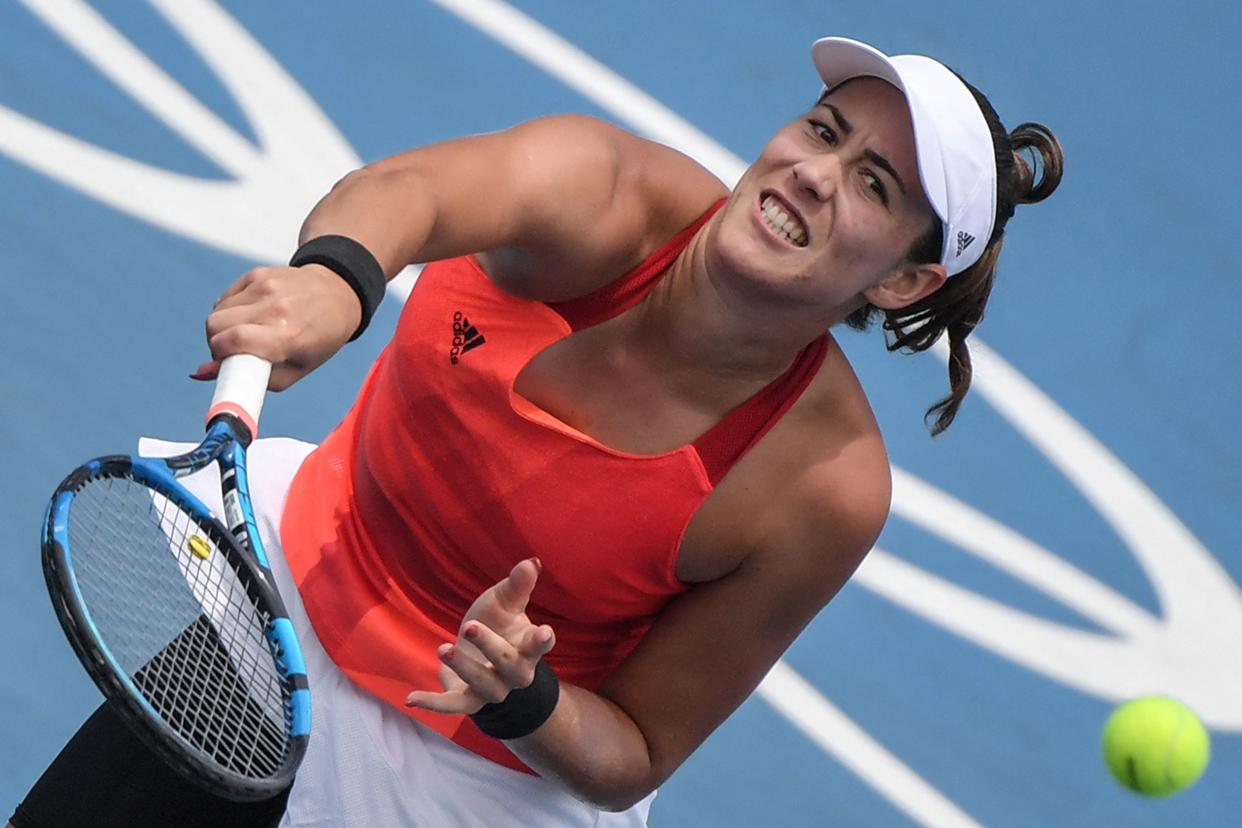 Spain's Garbine Muguruza serves to China's Wang Qiang during their Tokyo 2020 Olympic Games women's singles second round tennis match at the Ariake Tennis Park in Tokyo on July 26, 2021. (Photo by Tiziana FABI / AFP) (Photo by TIZIANA FABI/AFP via Getty Images)