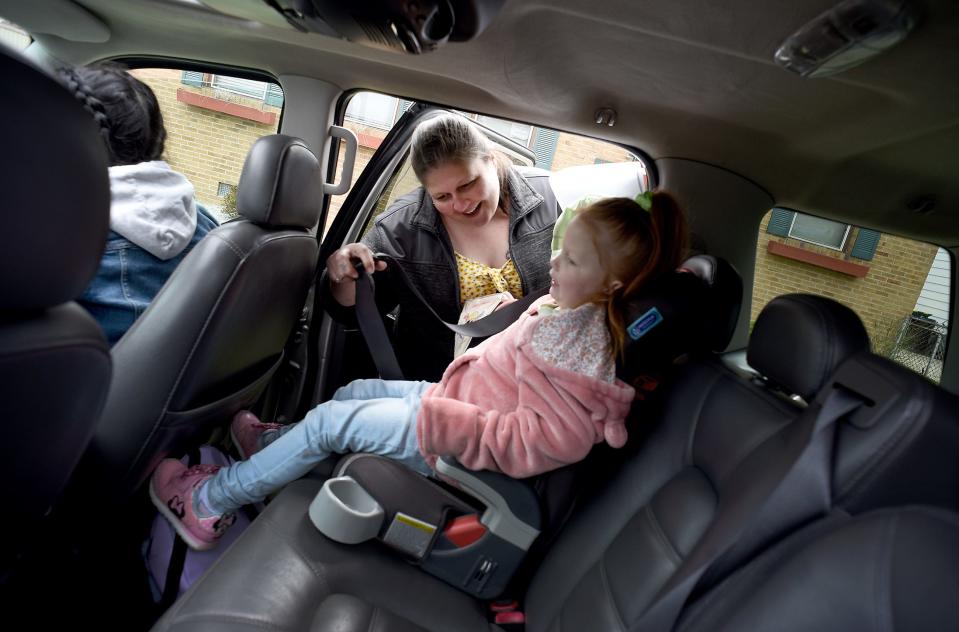 Maricella Ramirez, 34, buckles her daughter P'rrllis, 4, into her car seat on April 27 for the first time in her 2003 Ford Explorer she purchased to go for a ride.