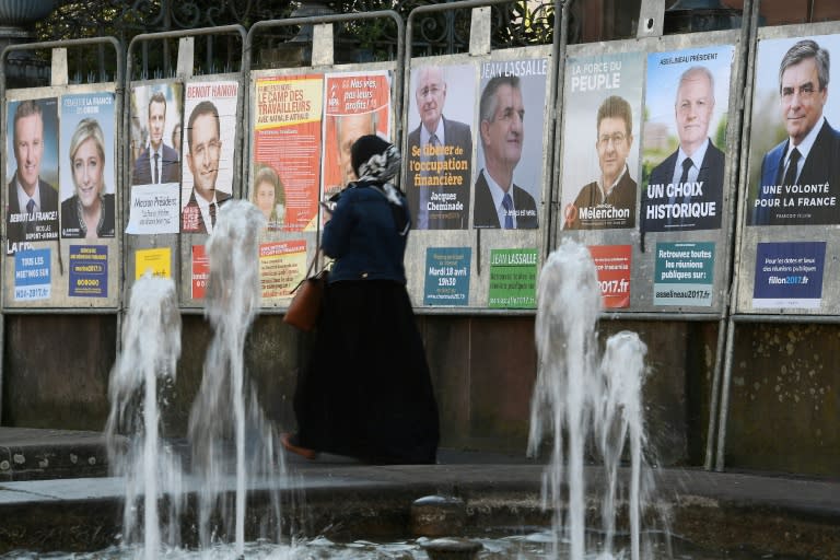 Campaign posters for the French presidential candidates cover a wall in Strasbourg, eastern France