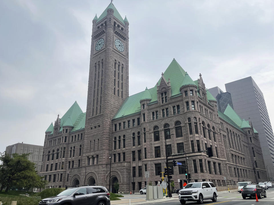 FILE - Cars drive past City Hall, June 28, 2023, in Minneapolis. The future of Uber and Lyft in Minneapolis has been a source of concern and debate in recent weeks after the City Council voted last month to require that ride-hailing companies pay drivers a higher rate while they are within city limits. (AP Photo/Trisha Ahmed, File)